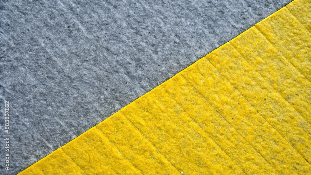 Vibrant yellow and textured gray surfaces intersect diagonally for a visually striking background , vibrant, yellow, textured Vibrant yellow and textured gray surfaces intersect diagonally for a visually striking background , vibrant, yellow, textured