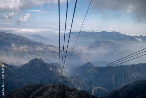 Cables pass along over the mountain range and beautiful sky.