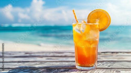 A refreshing orange cocktail rests on a beach table, glistening in the sunlight against a backdrop of sand and sea. This tropical drink evokes the essence of relaxation and seaside enjoyment.