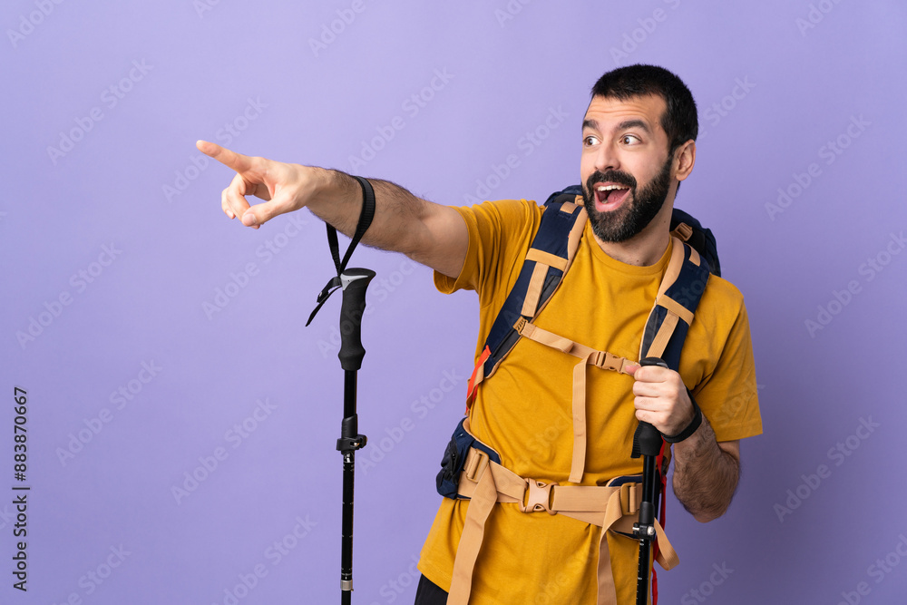 Caucasian handsome man with backpack and trekking poles over isolated background pointing away Caucasian handsome man with backpack and trekking poles over isolated background pointing away