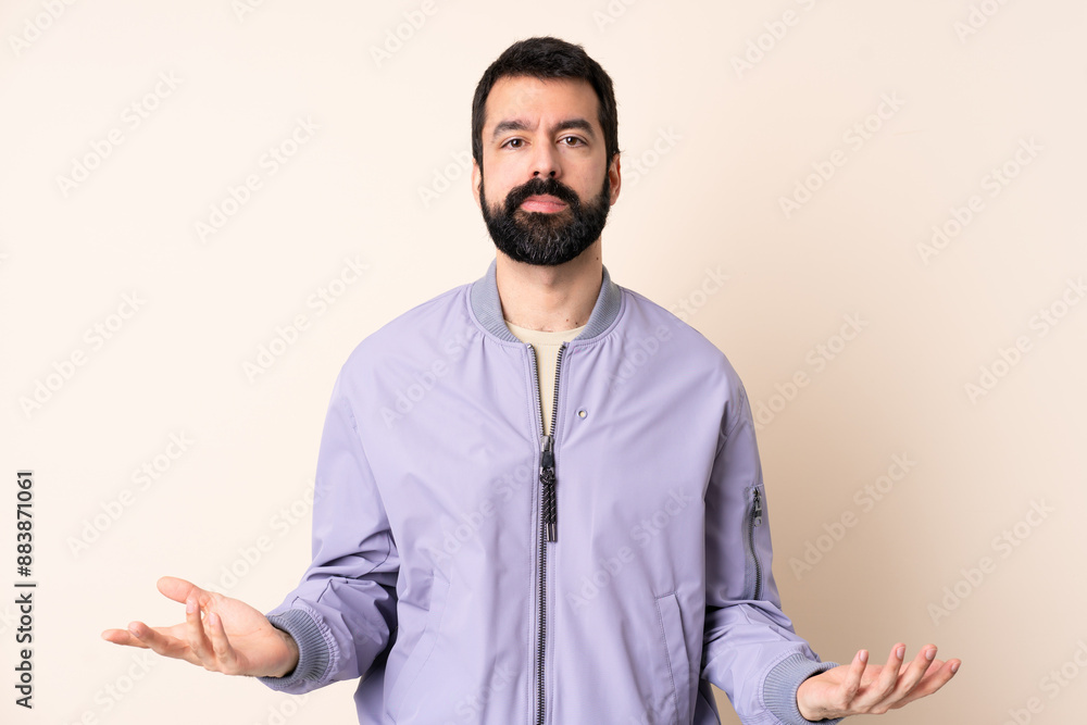 Caucasian man with beard wearing a jacket over isolated background having doubts Caucasian man with beard wearing a jacket over isolated background having doubts