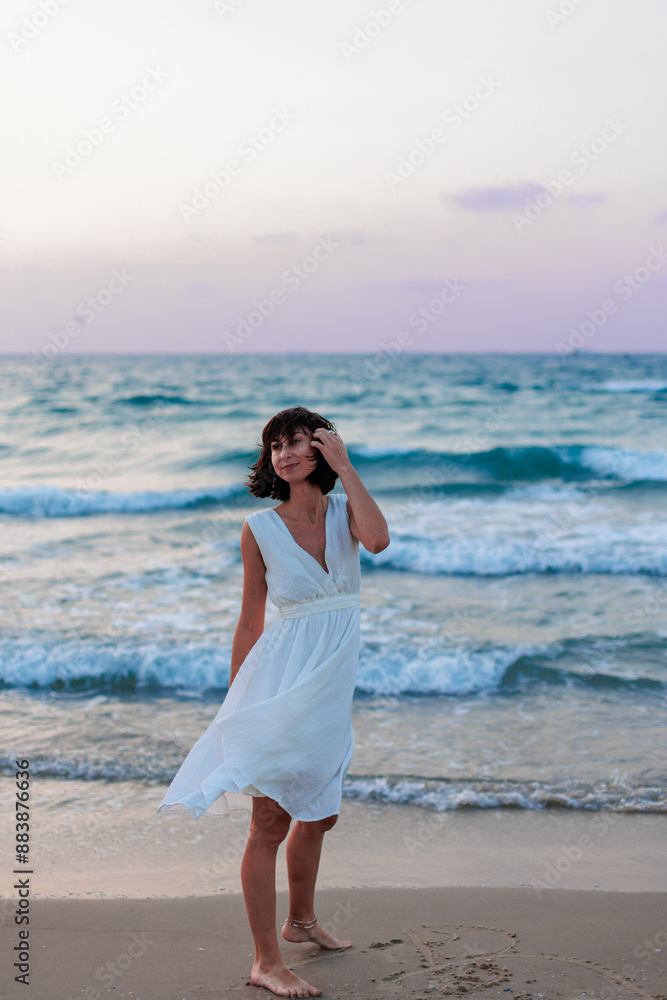 Happy traveler girl in a white summer dress enjoying a tropical paradise beach with turquoise sea. Happy traveler girl in a white summer dress enjoying a tropical paradise beach with turquoise sea.