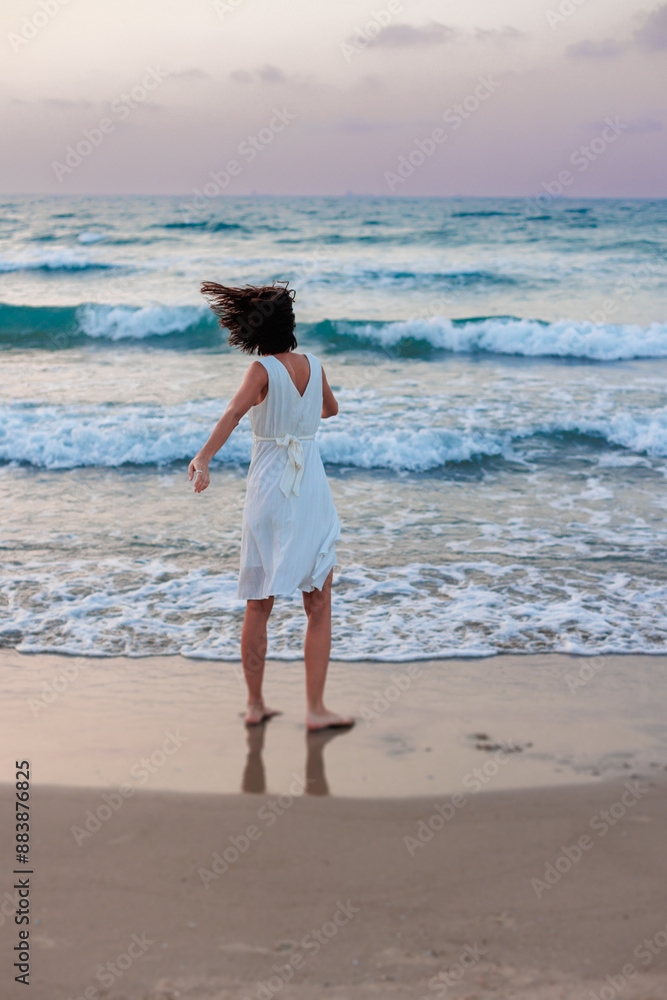 Happy traveler girl in a white summer dress enjoying a tropical paradise beach with turquoise sea. Happy traveler girl in a white summer dress enjoying a tropical paradise beach with turquoise sea.