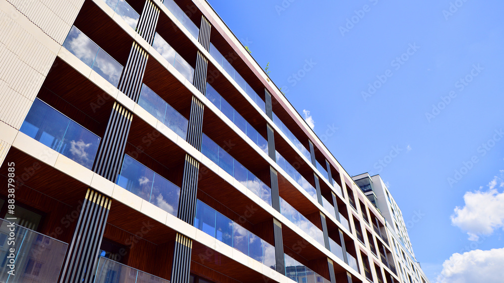 European residential architecture. Elements of modern architecture in apartment building. The facade of the building is made modern panels of different shades. European residential architecture. Elements of modern architecture in apartment building. The facade of the building is made modern panels of different shades.