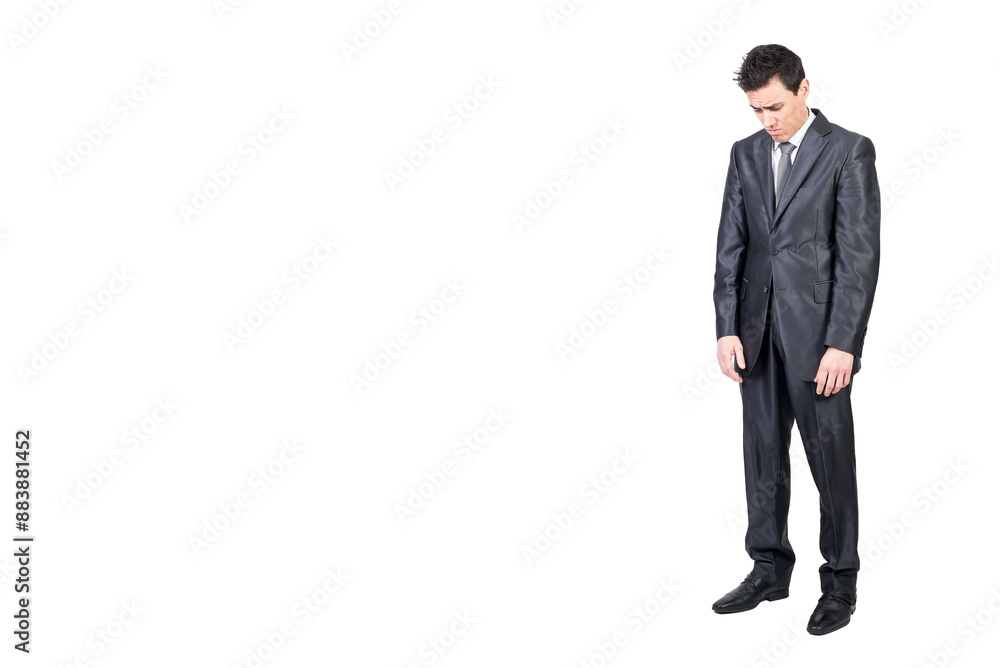 Sad young male manager looking down in white studio Sad young male manager looking down in white studio