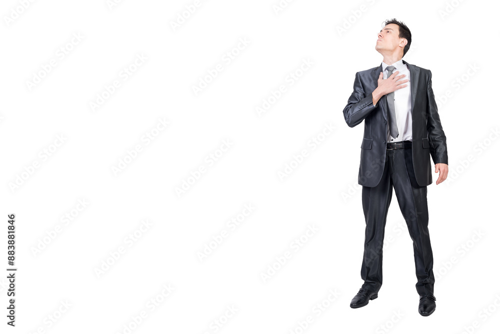 Serious man putting hand on chest and looking away Serious man putting hand on chest and looking away