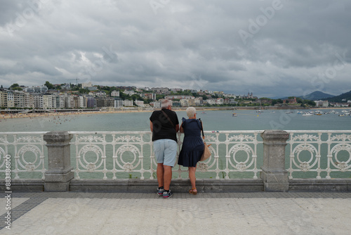 Couple visiting the shore of San Sebastian, Spain photo