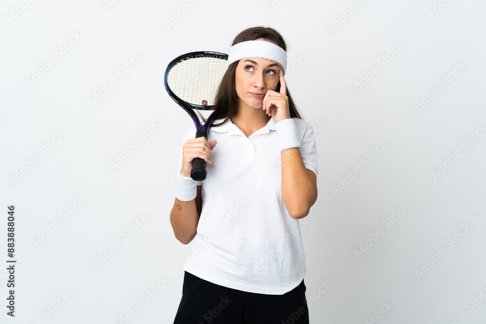 Young woman tennis player over isolated white background thinking an idea Young woman tennis player over isolated white background thinking an idea