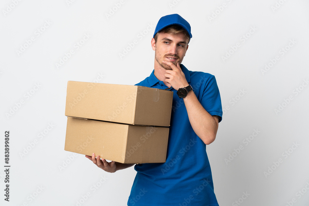 Young delivery blonde man isolated on white background looking to the side and smiling Young delivery blonde man isolated on white background looking to the side and smiling