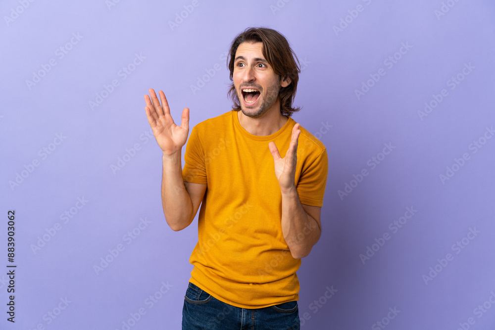 Young handsome man isolated on purple background with surprise facial expression Young handsome man isolated on purple background with surprise facial expression