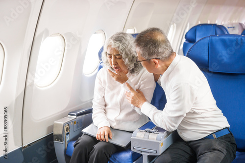 Tablou pe pânză A mature couple experiences air sickness during a long-haul flight due to disruptions in their body's biological clock from crossing multiple time zones, struggling to adapt to the new schedule