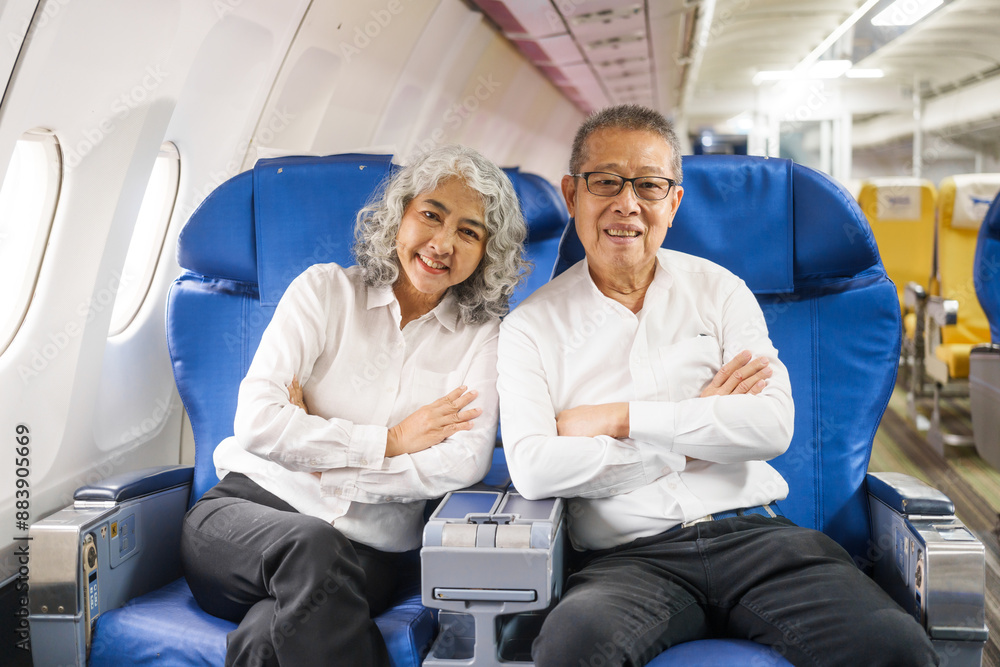 A mature couple enjoys a plane ride, seated near the window. They gaze out at the sky, savoring the view and the excitement of travel, creating cherished memories together. A mature couple enjoys a plane ride, seated near the window. They gaze out at the sky, savoring the view and the excitement of travel, creating cherished memories together.
