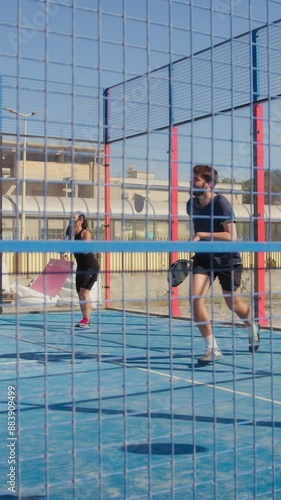 People Play Padel Sport In Blue Field Outdoors photo