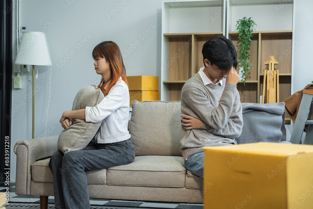 Unhappy young couple sitting apart, having problems in relationship, thinking of breaking up or divorce, upset, family lovers, man and woman avoid talking in relationship problems. Unhappy young couple sitting apart, having problems in relationship, thinking of breaking up or divorce, upset, family lovers, man and woman avoid talking in relationship problems.
