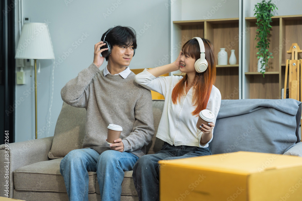 young couple helps put things in boxes and prepares, smiling happy moving to a new house. young couple helps put things in boxes and prepares, smiling happy moving to a new house.