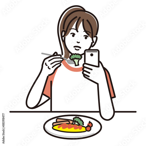 食事をしながらスマホを触る女の子