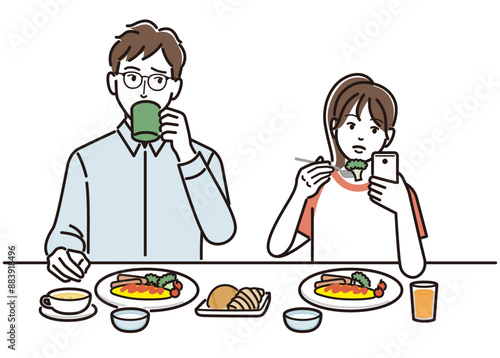 食事中にスマホを触る娘を訝しげに見る父親