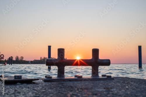 Sunrise on the shore and harbor of a lake in summer. Colorful sky with a wide view of the Horiont. Nature landscape at the marina of Balatonfüred Vitorláskikötő, Balaton, Lake Balaton, Siófok, Hungary photo