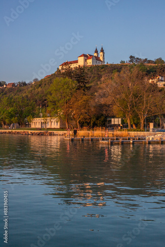 Sunrise on the shore and harbor of a lake in summer. Colorful sky with a wide view of the Horiont. Nature landscape at Tihany marina, Balaton, Lake Balaton, Siófok, Hungary photo