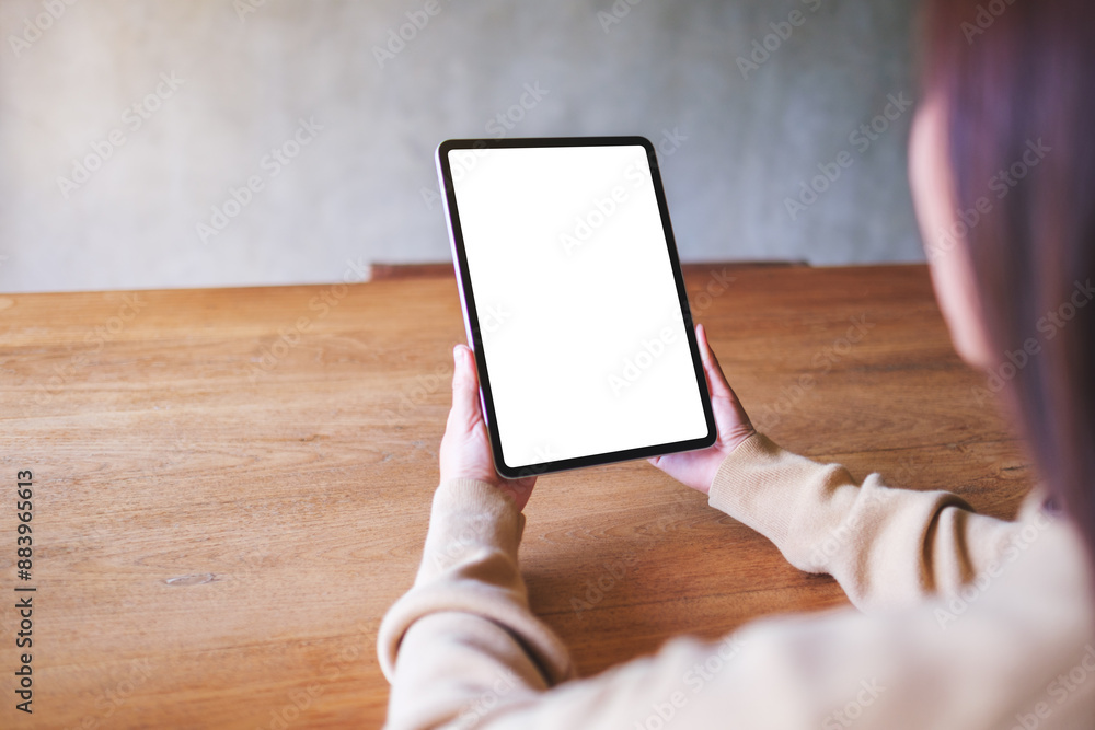© Farknot Architect - Mockup image of a woman holding digital tablet with blank white desktop screen © Farknot Architect - Mockup image of a woman holding digital tablet with blank white desktop screen
