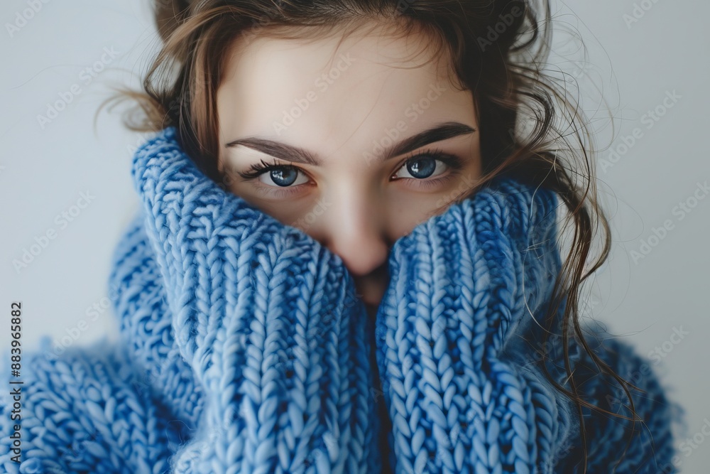 Lonely woman in blue turtleneck sweater, expressing depression and social phobia on blue monday Lonely woman in blue turtleneck sweater, expressing depression and social phobia on blue monday
