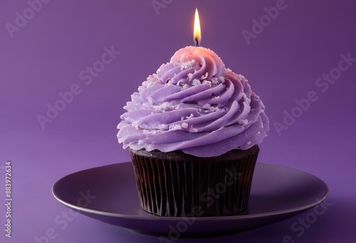 Purple Birthday Cupcake With a Lit Candle on Purple Background