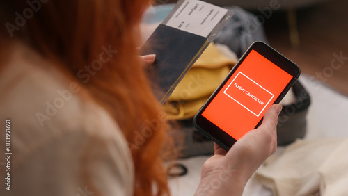 Tableau sur toile Sad unrecognizable woman at home angry holding phone cancel flight message delay