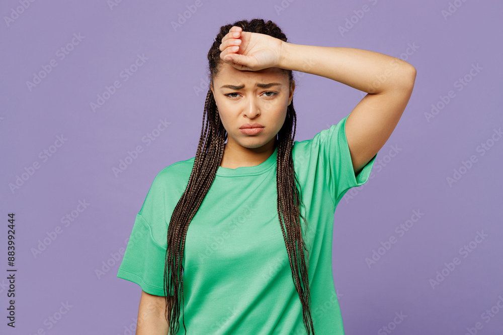 Young sick ill sad woman with dreadlocks wears green t-shirt casual clothes put hand on forehead suffer from headache look camera isolated on plain pastel light purple background. Lifestyle concept. Young sick ill sad woman with dreadlocks wears green t-shirt casual clothes put hand on forehead suffer from headache look camera isolated on plain pastel light purple background. Lifestyle concept.
