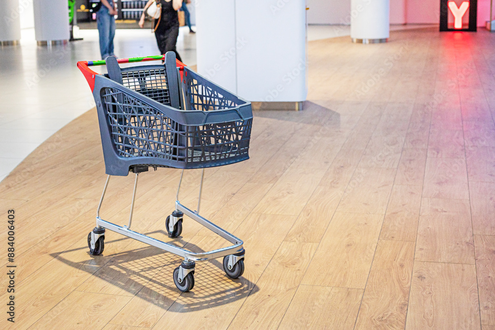 empty plastic cart in the interior of a shopping center. family shopping empty plastic cart in the interior of a shopping center. family shopping