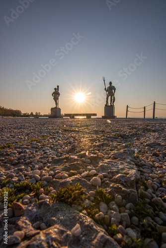 Sunrise on the shore and harbor of a lake in summer. Colorful sky with a wide view of the Horiont. Nature landscape at the marina of Balatonfüred Vitorláskikötő, Balaton, Lake Balaton, Siófok, Hungary photo