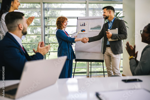 Tablou pe pânză Business man from Human Resource congratulates the new  ginger employee of their company after the job interview