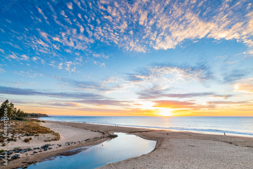 Christies Beach with people walking along the ocean shore at sunset, South Australia Christies Beach with people walking along the ocean shore at sunset, South Australia