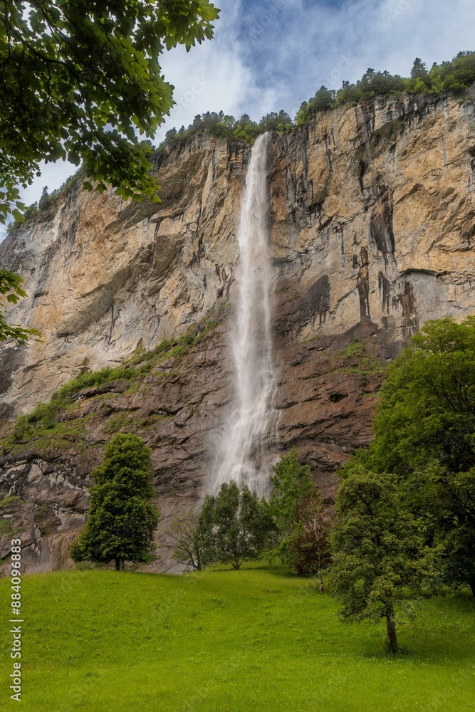 Fototapeta premium Scenic view of a waterfall cascading down a cliff. Lauterbrunnen Switzerland