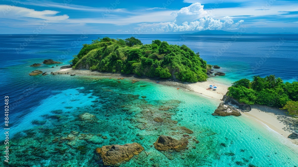 Fototapeta premium Turquoise waves kiss a tropical island's white sand shore under a vibrant summer sky