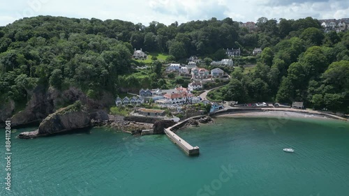 Babbacombe, South Devon, England: DRONE VIEWS: The drone circles Babbacombe beach and quay wall showing a moored boat and luxury apartment. Babbacombe is a popular UK holiday destination (Clip 13). photo