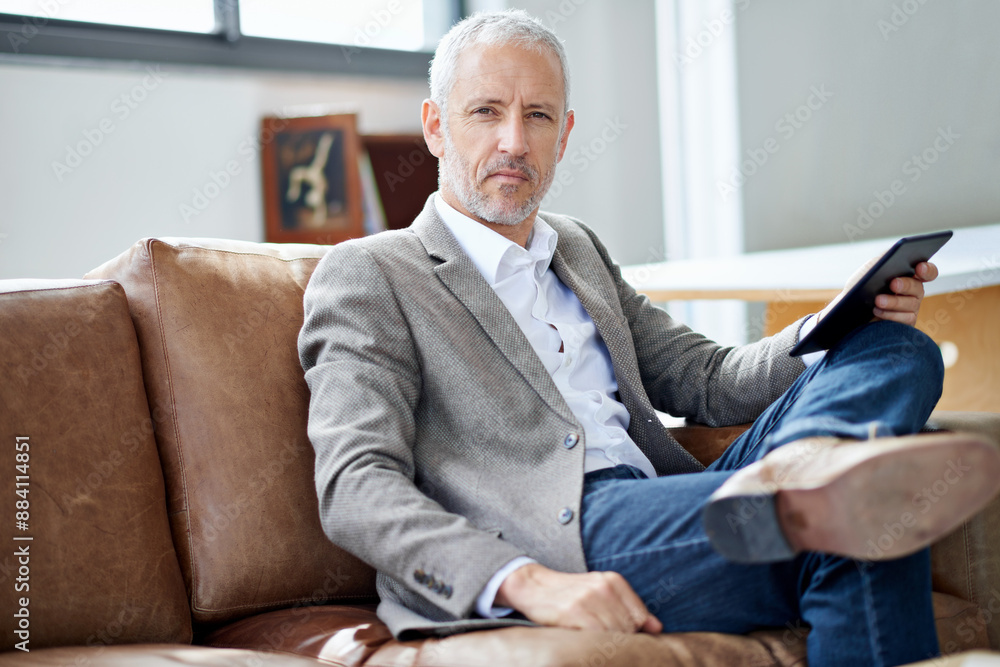 Couch, portrait and mature man with tablet for reading news, information and topic of interest in home. Sofa, male reader and relax with online article, current events and digital story for knowledge Couch, portrait and mature man with tablet for reading news, information and topic of interest in home. Sofa, male reader and relax with online article, current events and digital story for knowledge