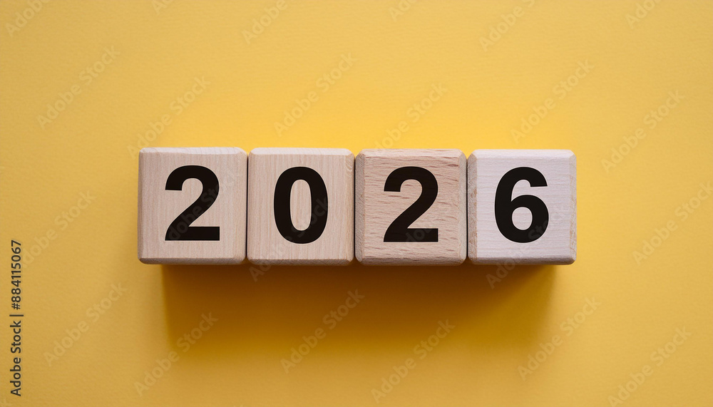 Wooden cubes with number 2026 on yellow backdrop. New year. Wood blocks. Close-up. Flat lay. Wooden cubes with number 2026 on yellow backdrop. New year. Wood blocks. Close-up. Flat lay.