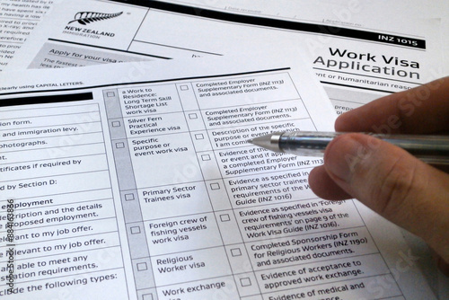 Man filling a New Zealander visa application form photo