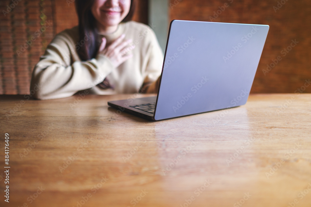 Closeup of a young woman using laptop computer for video call and working or studying online at home Closeup of a young woman using laptop computer for video call and working or studying online at home