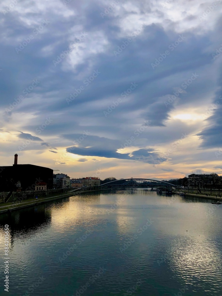 Fototapeta premium Krakow, Poland. Sunset sky over the Vistula River, view from the bridge.
