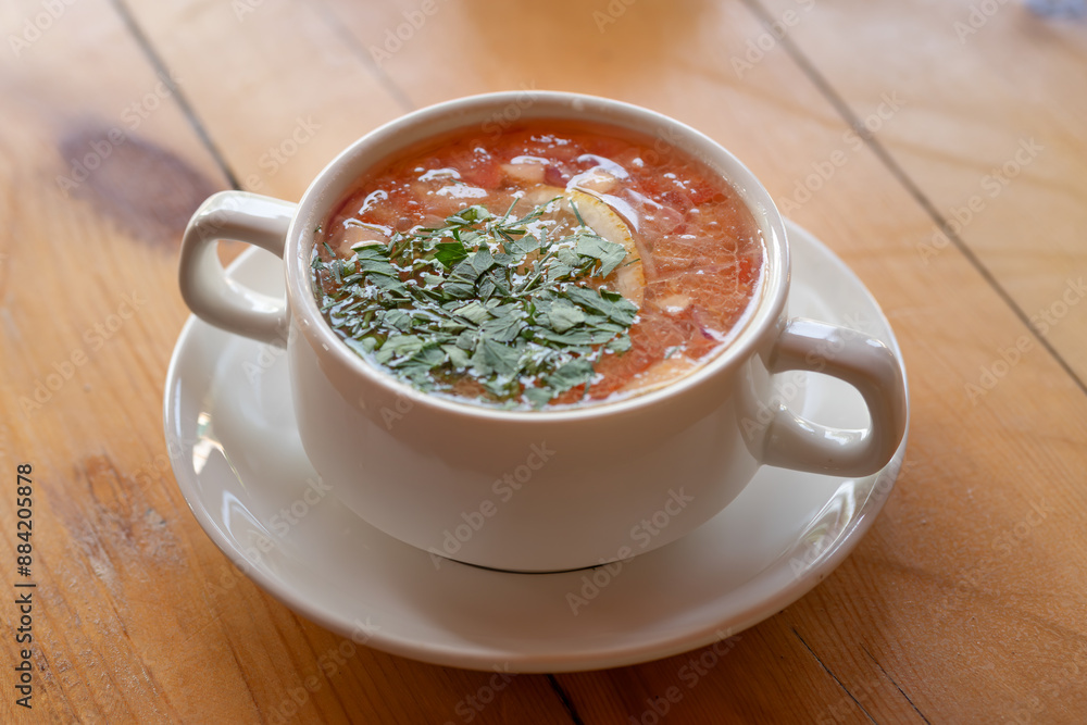 A white bowl of hot soup on a wooden table is a comforting and savory dish that is appetizing A white bowl of hot soup on a wooden table is a comforting and savory dish that is appetizing