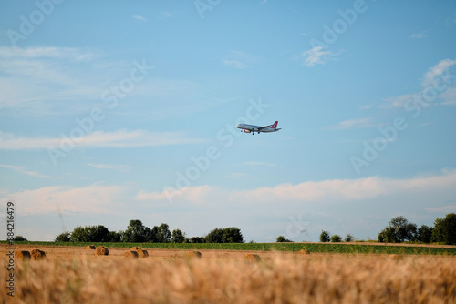 Poland, Europe - 10 07 2024: Turkish Airlines Aircraft Flying Before Landing Over Field with Hay Bales