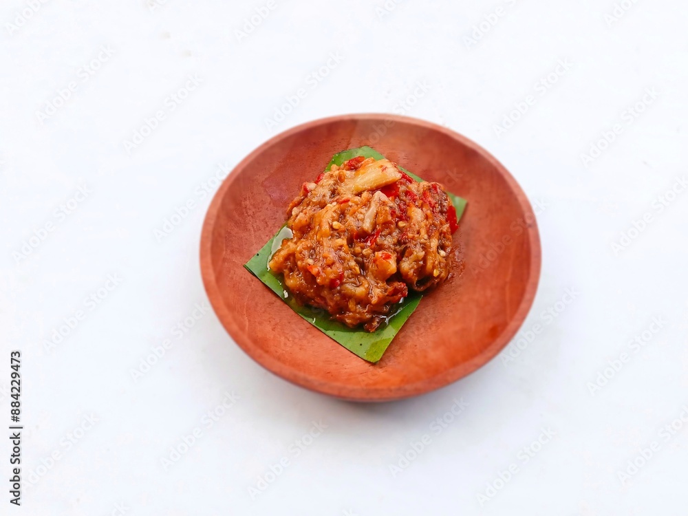 eggplant chili sauce, accompaniment to spicy food. fresh and hot traditional side dish. chili sauce made from eggplant served on a wooden plate against white background
eggplant chili sauce, accompaniment to spicy food. fresh and hot traditional side dish. chili sauce made from eggplant served on a wooden plate against white background