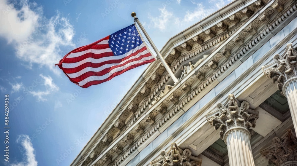 Fototapeta premium Close-up of the US flag flying in front of the US Capitol building, blue sky background.