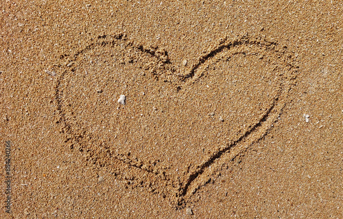 heart drawn or love sign on the sand beach