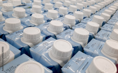 Easy to open screw caps on rows of milk cartoon. Milk cartoon packaging on rows