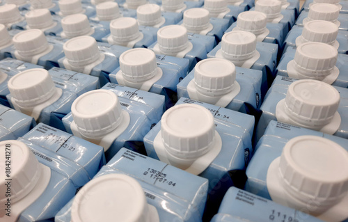Easy to open screw caps on rows of milk cartoon. Milk cartoon packaging on rows