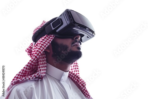 Saudi Gulf Arab man wearing a traditional white thobe and red shemagh, use VR virtual reality games on white background.