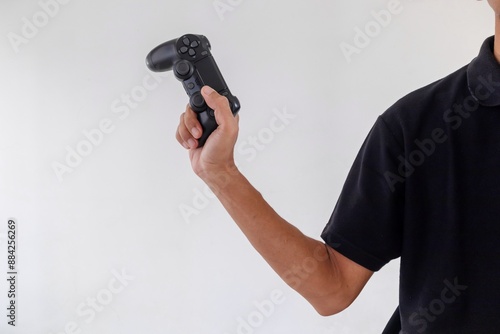 Man holding a gamepad controller or joystick on a white background