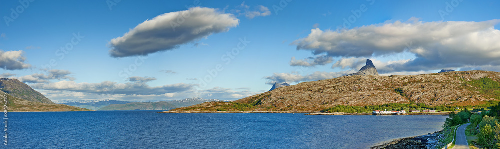 Landscape, mountains and fjord with water, nature and horizon with clouds in sky, ecosystem and sustainability. Outdoor, sea and hill with forest, growth and coastal environment in summer in Norway Landscape, mountains and fjord with water, nature and horizon with clouds in sky, ecosystem and sustainability. Outdoor, sea and hill with forest, growth and coastal environment in summer in Norway